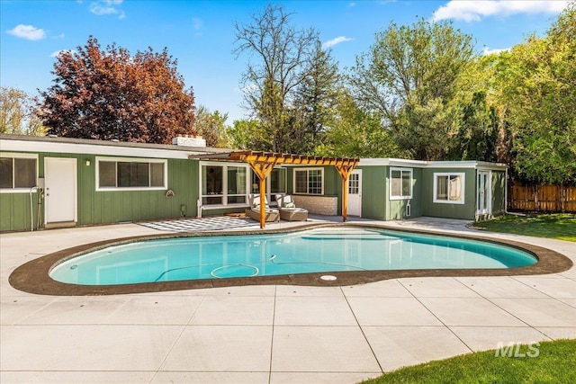 rear view of house featuring a pergola, a fenced in pool, fence, and a patio