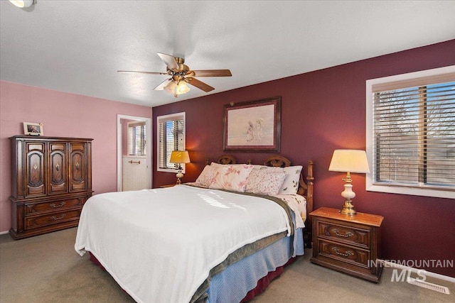 bedroom featuring ceiling fan and light carpet