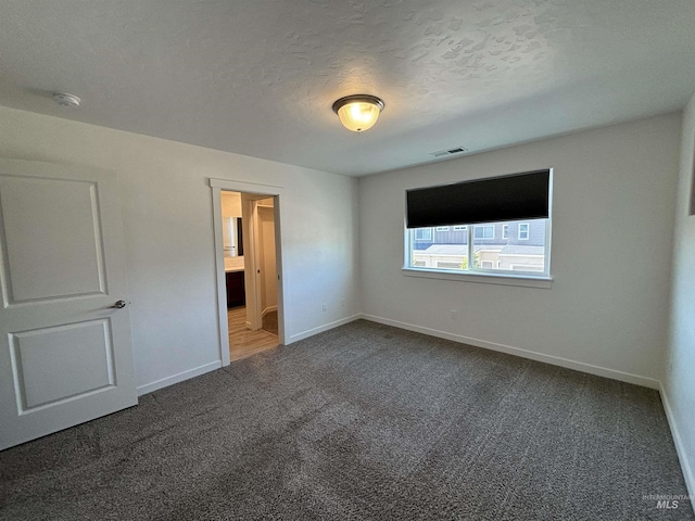 5619 E Bollo St, Nampa, ID 83687 - unfurnished bedroom with carpet floors, baseboards, and a textured ceiling