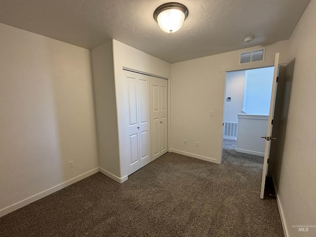 5619 E Bollo St, Nampa, ID 83687 - unfurnished bedroom with baseboards, dark colored carpet, and a closet