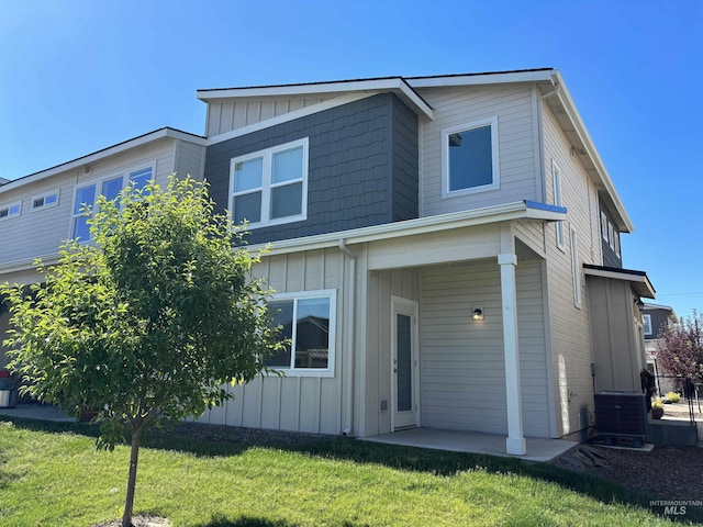 5619 E Bollo St, Nampa, ID 83687 - view of front of home featuring board and batten siding, a front lawn, and central AC