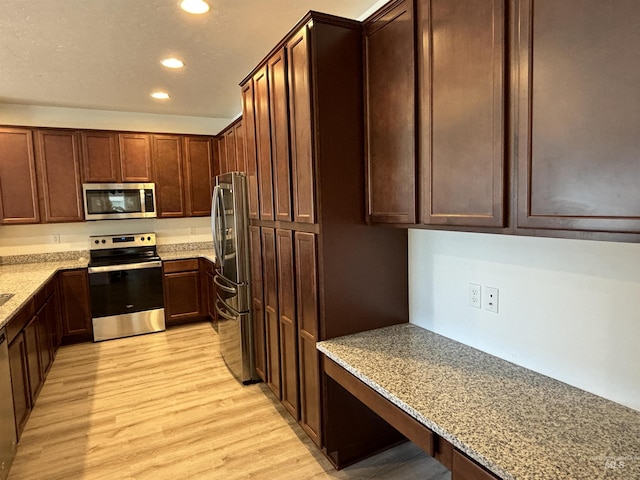 5619 E Bollo St, Nampa, ID 83687 - kitchen with stainless steel appliances, recessed lighting, light wood-style flooring, and light stone countertops