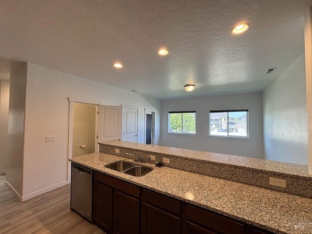 5619 E Bollo St, Nampa, ID 83687 - kitchen with dishwasher, a sink, wood finished floors, light stone counters, and dark brown cabinets