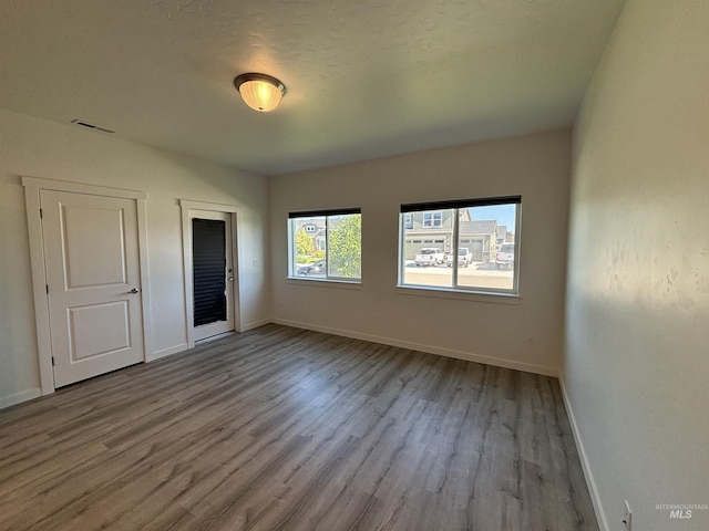 5619 E Bollo St, Nampa, ID 83687 - unfurnished bedroom with wood finished floors, baseboards, and a closet