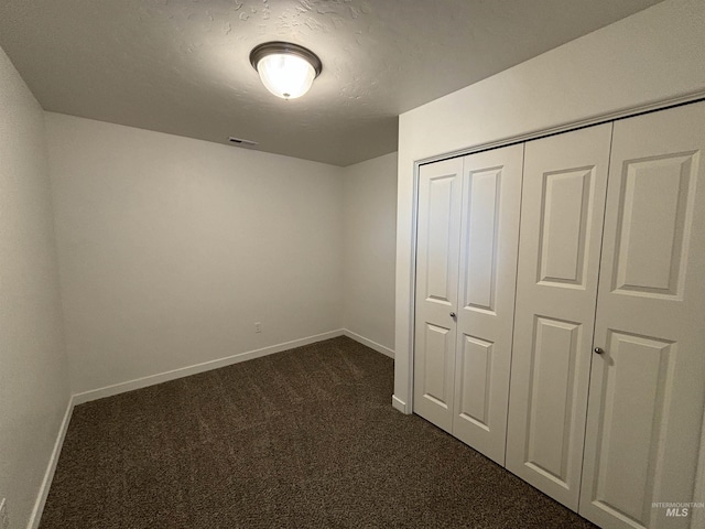 5619 E Bollo St, Nampa, ID 83687 - unfurnished bedroom featuring dark carpet, baseboards, and a closet