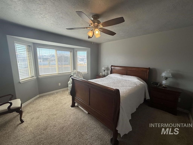 bedroom featuring ceiling fan, baseboards, a textured ceiling, and light colored carpet