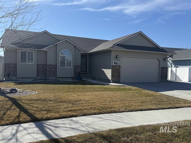 single story home featuring a front yard, driveway, an attached garage, and fence