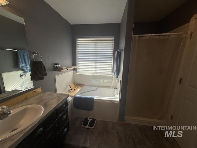 full bath featuring a shower with curtain, vanity, a bath, and wood finished floors