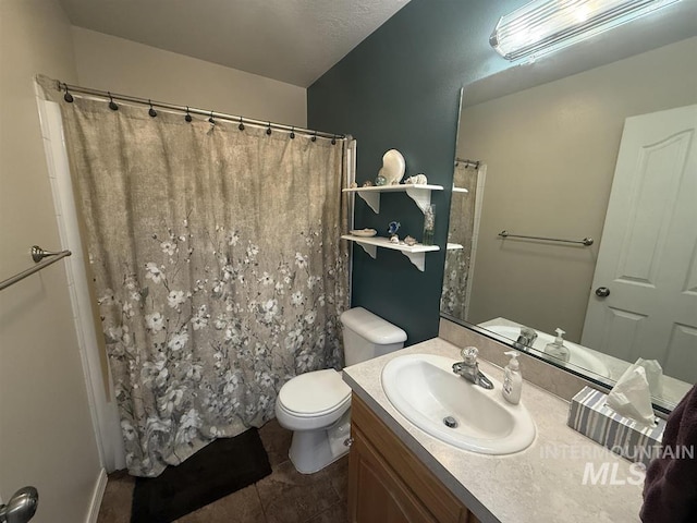 full bath featuring a shower with shower curtain, vanity, toilet, and tile patterned floors