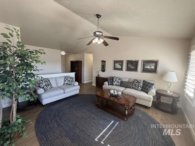 living room featuring visible vents, vaulted ceiling, a textured ceiling, and wood finished floors