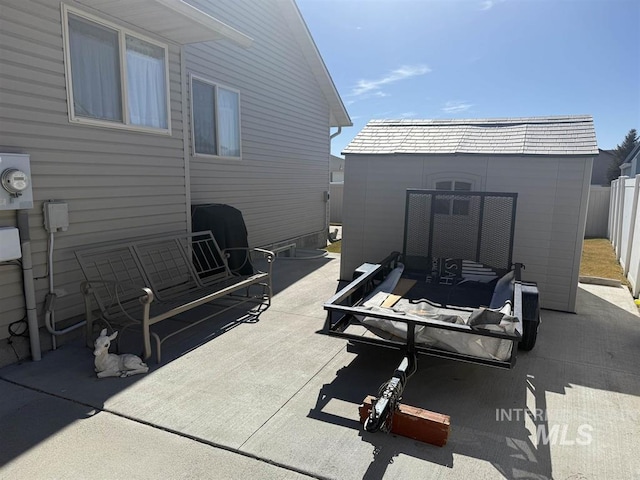 view of patio featuring a storage unit, outdoor lounge area, an outdoor structure, and fence