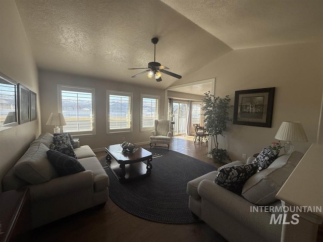 living area with lofted ceiling, ceiling fan, a textured ceiling, and wood finished floors