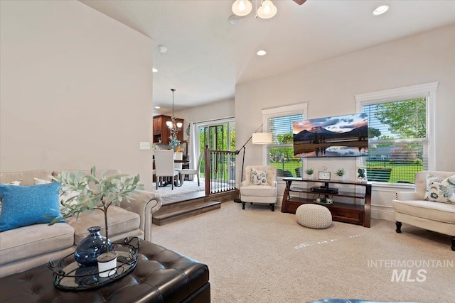 carpeted living area with a chandelier and recessed lighting