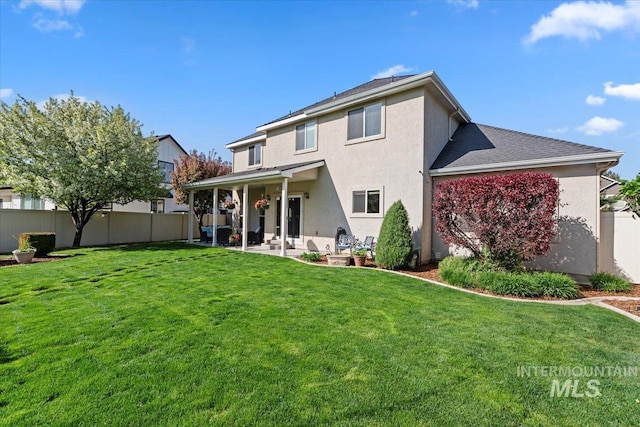 rear view of property featuring stucco siding and a patio area