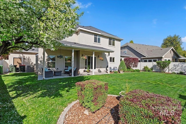 rear view of property with stucco siding, outdoor lounge area, and a patio area