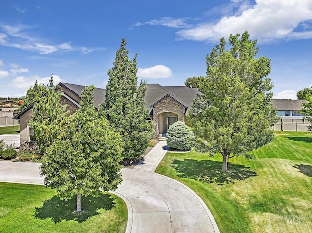 view of front facade with a front lawn and stone siding