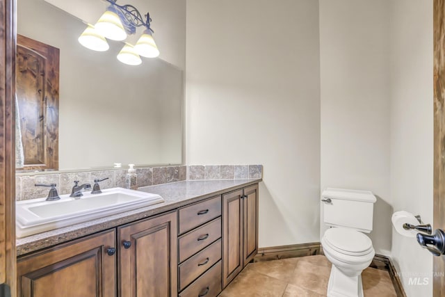 bathroom featuring tile patterned floors, vanity, and toilet