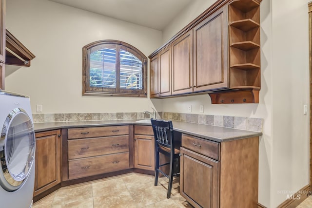 clothes washing area featuring cabinet space and washer / clothes dryer
