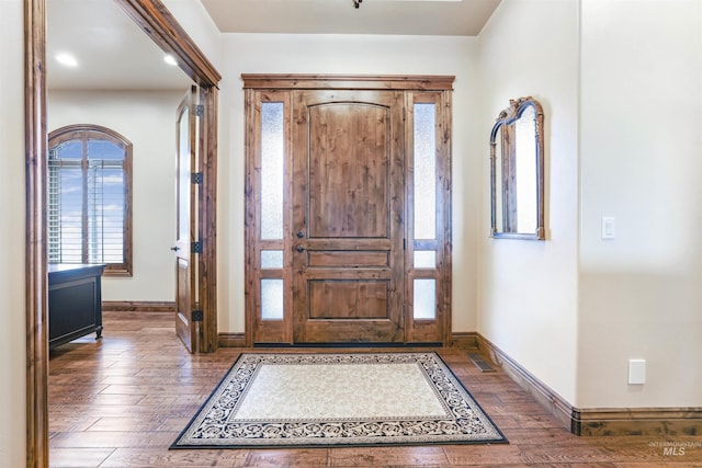 foyer featuring visible vents, hardwood / wood-style flooring, and baseboards