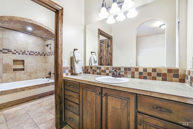 full bath with an inviting chandelier, tile patterned flooring, decorative backsplash, vanity, and tub / shower combination
