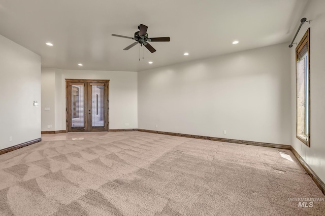 spare room with baseboards, recessed lighting, a ceiling fan, and light colored carpet