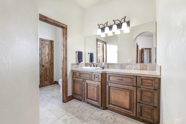 bathroom featuring vanity, toilet, and tile patterned flooring