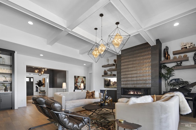 living room featuring hardwood / wood-style flooring, a large fireplace, beamed ceiling, and coffered ceiling