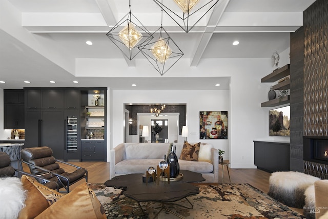 living room with beam ceiling, a fireplace, and hardwood / wood-style floors