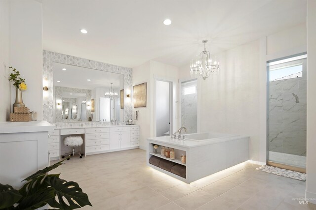 bathroom with shower with separate bathtub, vanity, and tile patterned floors