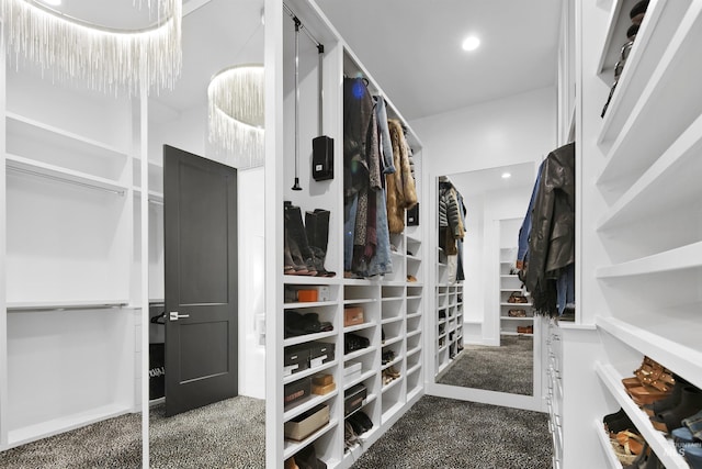 walk in closet featuring dark carpet