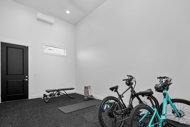 exercise room with an AC wall unit and vaulted ceiling