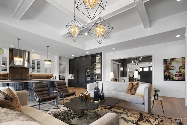 living room with beam ceiling and hardwood / wood-style floors