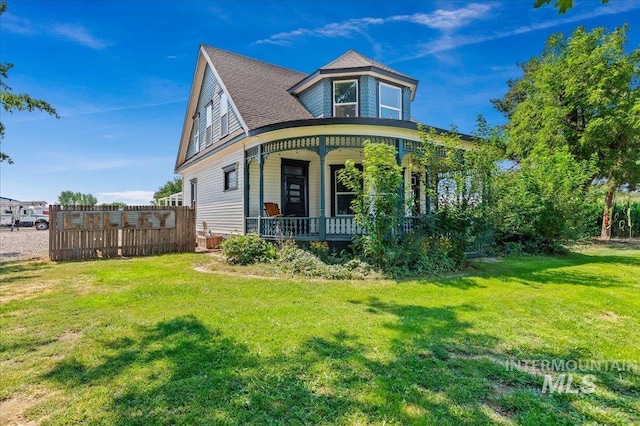 view of front of home with a front yard and a porch