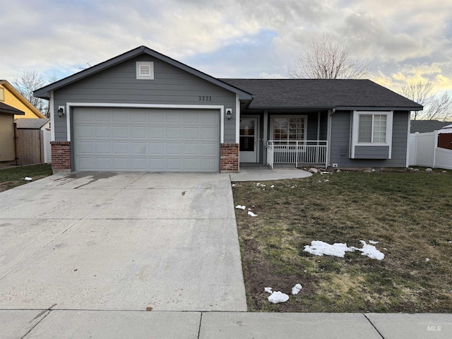 ranch-style home with a garage, a porch, and a front lawn