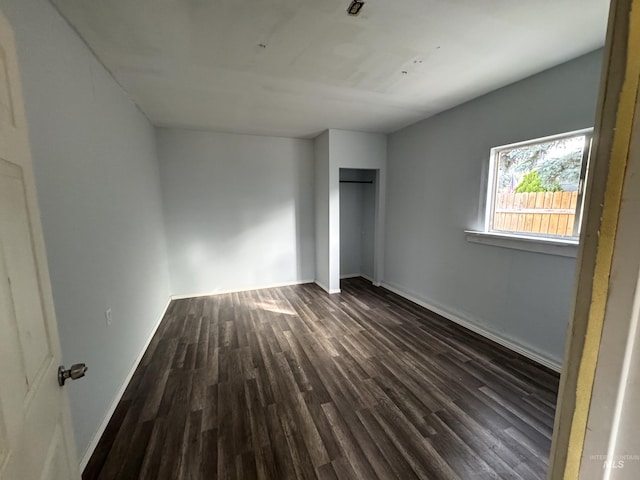 unfurnished bedroom featuring dark hardwood / wood-style flooring