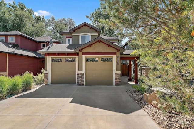 2174 S Myers Pl, Boise, ID 83706 - view of front of house with driveway, stone siding, stucco siding, an attached garage, and roof with shingles