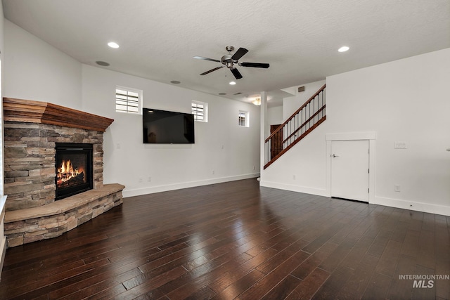 2174 S Myers Pl, Boise, ID 83706 - unfurnished living room with ceiling fan, a stone fireplace, hardwood / wood-style flooring, baseboards, and recessed lighting