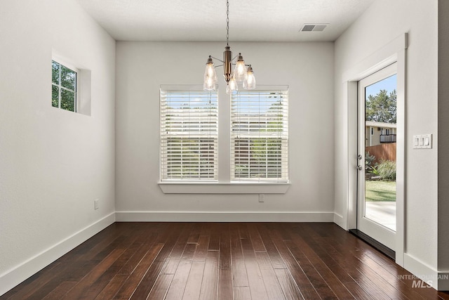 2174 S Myers Pl, Boise, ID 83706 - unfurnished dining area featuring a chandelier, healthy amount of natural light, dark wood-style floors, and baseboards