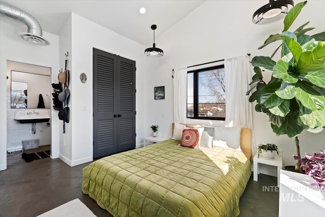 bedroom with vaulted ceiling and a closet