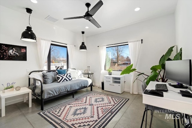 bedroom featuring ceiling fan and multiple windows