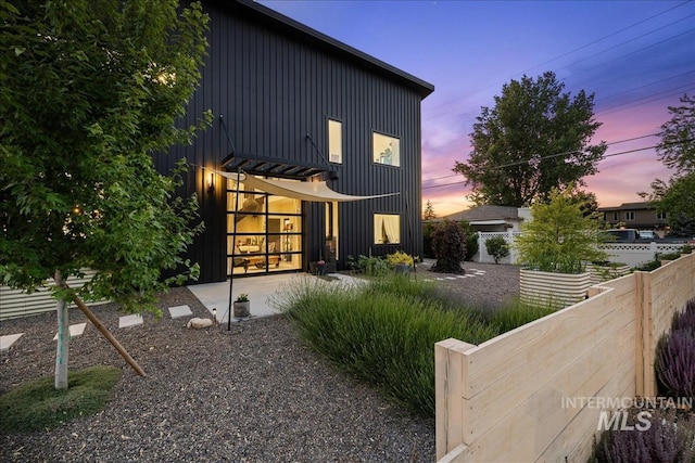 view of back house at dusk