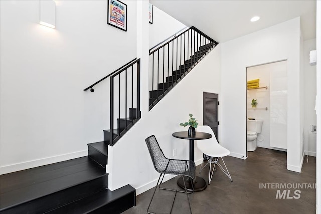 staircase with concrete floors