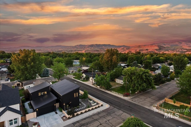 aerial view at dusk featuring a mountain view