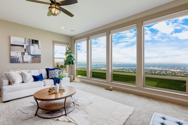 carpeted living room featuring ceiling fan