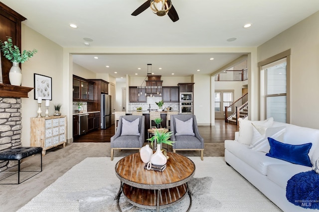 living room featuring ceiling fan and hardwood / wood-style flooring