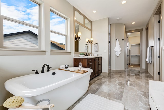 bathroom featuring a bathing tub, tile patterned floors, and vanity