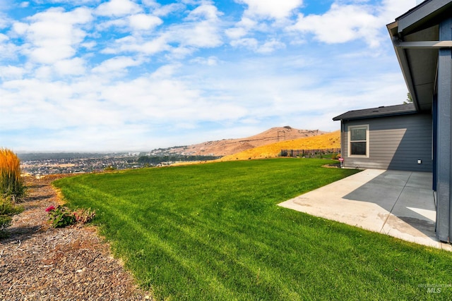 view of yard with a patio and a mountain view