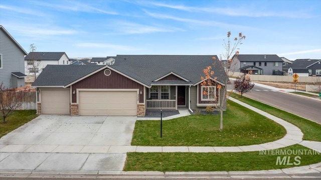 view of front of house featuring a front lawn, a garage, and covered porch