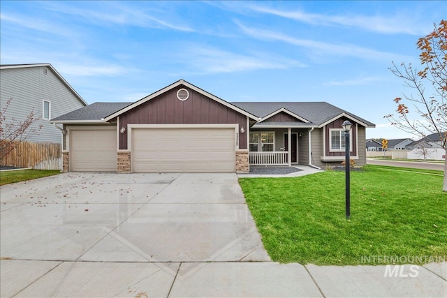 single story home with a garage, a front yard, and a porch