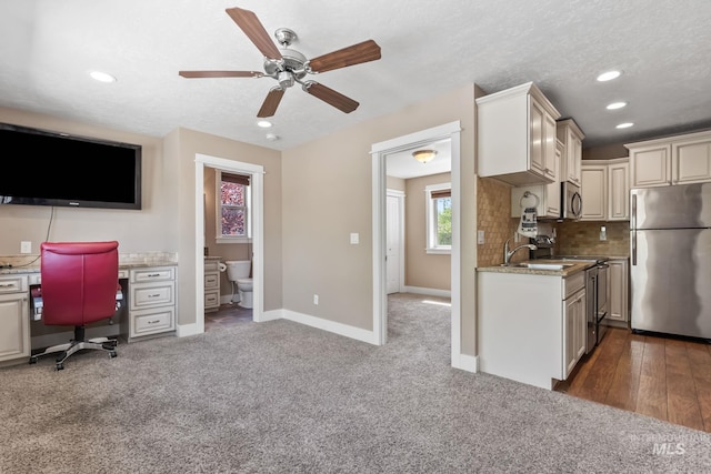 kitchen featuring recessed lighting, backsplash, a ceiling fan, a sink, and appliances with stainless steel finishes